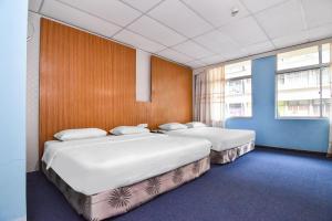Säng eller sängar i ett rum på Super OYO 90602 Hotel Hsiang Garden