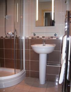 a bathroom with a sink and a shower at Albany House in Penrith