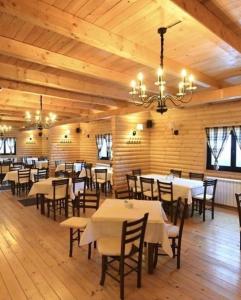 a dining room with tables and chairs and a chandelier at Kopaonik Župa 505 in Kopaonik