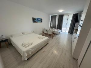 a bedroom with a bed and a table and chairs at Summer Apartments Kabakum by Flat Manаger in Golden Sands