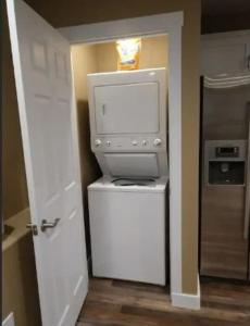 a room with a computer on top of a refrigerator at Harbour Village Retreat in Garden City