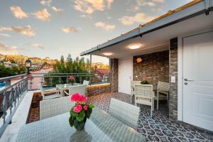 a balcony with a table with flowers on it at Azalea Mansion Oldcity in Istanbul