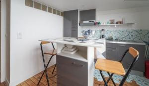 a small kitchen with a table and two chairs at Solo traveler's best stop near Paris in Bagnolet