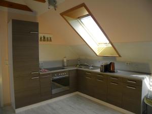 a kitchen with a skylight and a sink and a oven at Ferienwohnung an der Schorfheide in Schorfheide