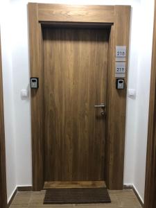 a wooden door in a room with a sign on it at Apartmani A in Kopaonik +32 photos