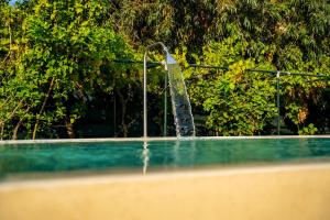 a water fountain in a swimming pool at Heliophos Villa Aitheria in Kiotari