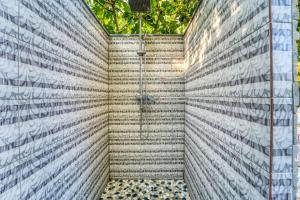 a bathroom with a shower in a brick wall at Heliophos Villa Aitheria in Kiotari