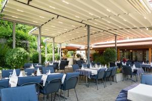 a group of tables and chairs under a pavilion at Hotel Bahnhof Zollikofen in Zollikofen