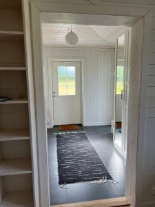 a hallway with a door leading to a room at Nice apartment, rural idyll just outside Karlstad in Karlstad