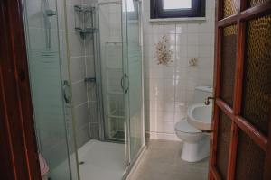a bathroom with a glass shower and a toilet at Ağva Marina House in Istanbul
