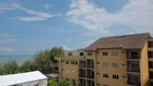 an apartment building with the ocean in the background at Gold Coast Morib Resort in Banting