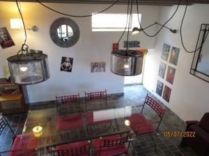 an overhead view of a restaurant with red chairs and lights at Interludes Normands in Ver-sur-Mer