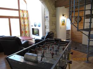 a living room with a large chess board on a table at Interludes Normands in Ver-sur-Mer