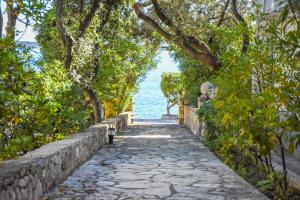 a stone path next to a body of water at Seaside holiday house Mandre, Pag - 19691 in Kolan