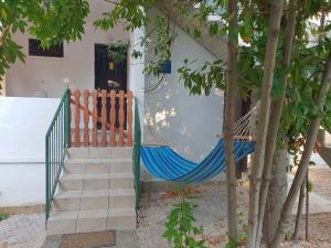 a hammock in front of a house at Apartments by the sea Necujam, Solta - 19697 in Grohote