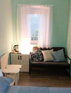 ein Wohnzimmer mit einem Sofa und einem Fenster in der Unterkunft Mike's Rooms in Kobarid