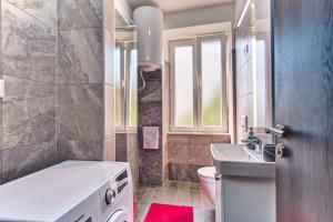 een badkamer met een bad, een wastafel en een toilet bij Apartments with a parking space Mali Losinj, Losinj - 19618 in Mali Lošinj +15 foto's