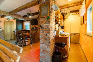 a living room with a brick wall and a table at Family friendly house with a parking space Lokve, Gorski kotar - 19457 in Lokve