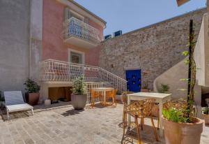 a patio with chairs and tables and a staircase at Apartments by the sea Veli Losinj, Losinj - 19620 in Veli Lošinj