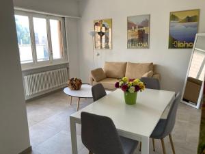 a living room with a table and a couch at Lugano Viganello in Lugano