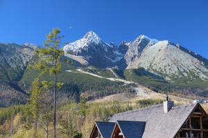 a mountain view with a house in the foreground at Matrix in Vysoke Tatry - Tatranska Lomnica.