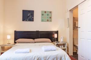 a bedroom with a large bed with two pillows on it at City Centre Guest House in Gloucester