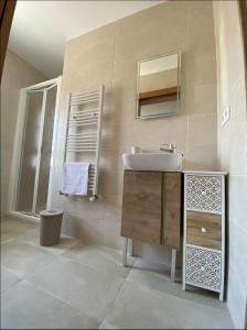 a bathroom with a sink and a mirror at Apartamento turístico La Torre in Santacara