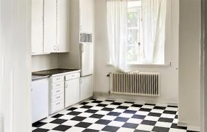 a kitchen with a black and white checkered floor at Cozy Apartment In Kristinehamn in Edet