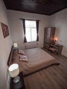 a bedroom with a large bed and a window at Къща за гости Светулките Fireflies Guest House 