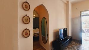 a living room with a mirror and a tv at Lulia in Jerusalem