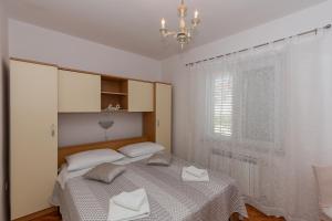 Postel nebo postele na pokoji v ubytování Apartments Tolic