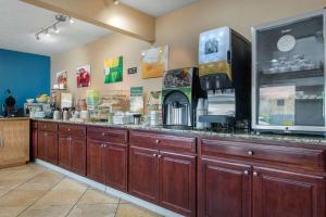 a bar with wooden cabinets in a store at Quality Inn Columbus-East in Columbus