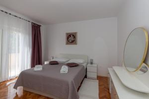 Postel nebo postele na pokoji v ubytování Apartments Tolic