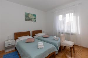 Postel nebo postele na pokoji v ubytování Apartments Tolic