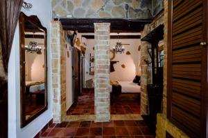 a hallway with a room with a bed and a mirror at Hotel Rural Finca La Herencia in Guadalcanal