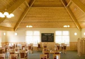 a classroom with desks and a chalkboard in a building at Lakes and woodlands Overstone Holiday Park in Northampton