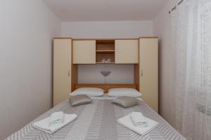 Postel nebo postele na pokoji v ubytování Apartments Tolic