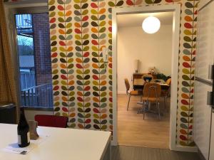 a hallway with a dining room with a patterned wall at African heritage Tervuren in Tervuren +34 photos