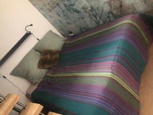 a bed with a colorful blanket on top of it at Super Host im Bremer Viertel. in Bremen