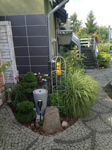 a garden with a toilet and some plants and a building at Pokoje Gościnne Cisowa in Zielona Góra