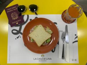 a plate of food with a sandwich on a table at La Casa di Luna in Naples