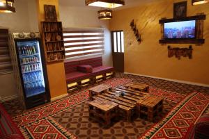 a living room with a table and a television in it at Petra Wooden House in Wadi Musa