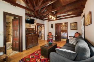 a living room with a couch and a table at MAROYDA STONEHOUSE in Panayia