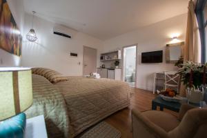 a bedroom with a bed and a living room at Operetta House in Larnaca
