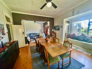 a dining room with a table and chairs and a couch at 23 Ambleside Holiday Retreat by the sea in Port Shepstone