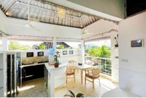 a kitchen and dining room with a table and chairs at Blue Lagoon Apartment 3br in Kuta