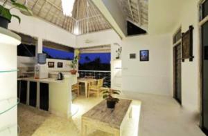 a living room with a table and a kitchen at Blue Lagoon Apartment 3br in Kuta