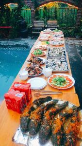 a long table filled with different types of food at Tam Coc Amanda Villas in Ninh Binh