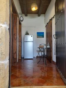 a kitchen with a white refrigerator and a table at La casetta di Tina in Marzamemi