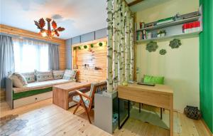 a room with a desk and a couch and a table at Cozy Home In Gornja Konjscina With Wifi in Hrašćina